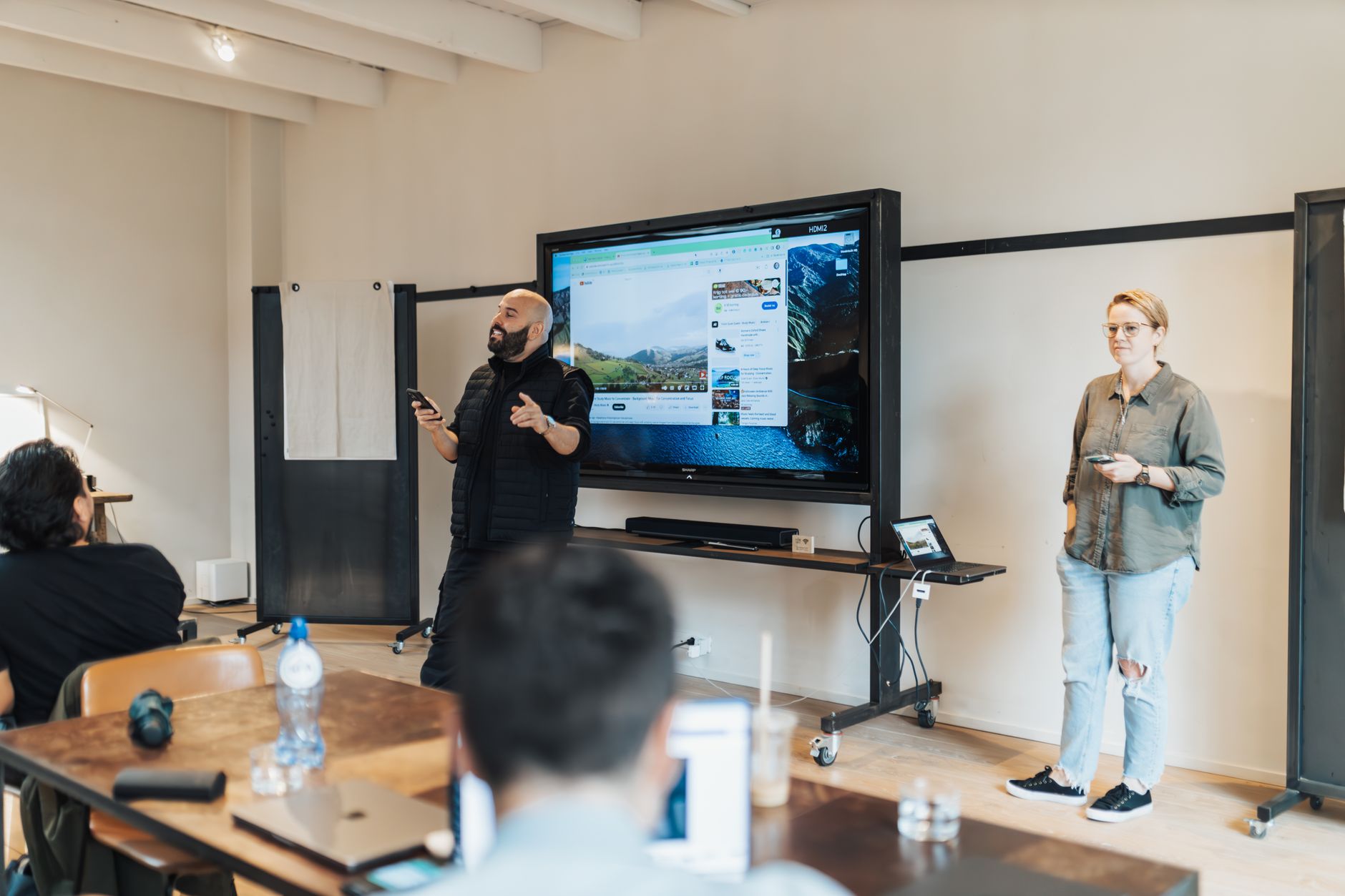 Trainers presenting to a team in a workshop room